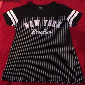 Black shirt with white stripes with text